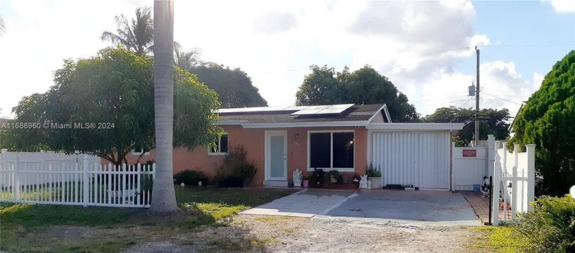 This home features three bedrooms, two bathrooms, and a garage - Beach Home for sale in Dania, Florida on Beachhouse.com