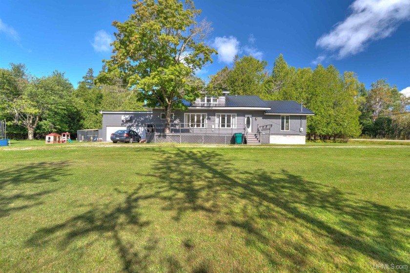 Welcome to this warm and inviting 3-bedroom, 2-bath home nestled - Beach Home for sale in Manistique, Michigan on Beachhouse.com