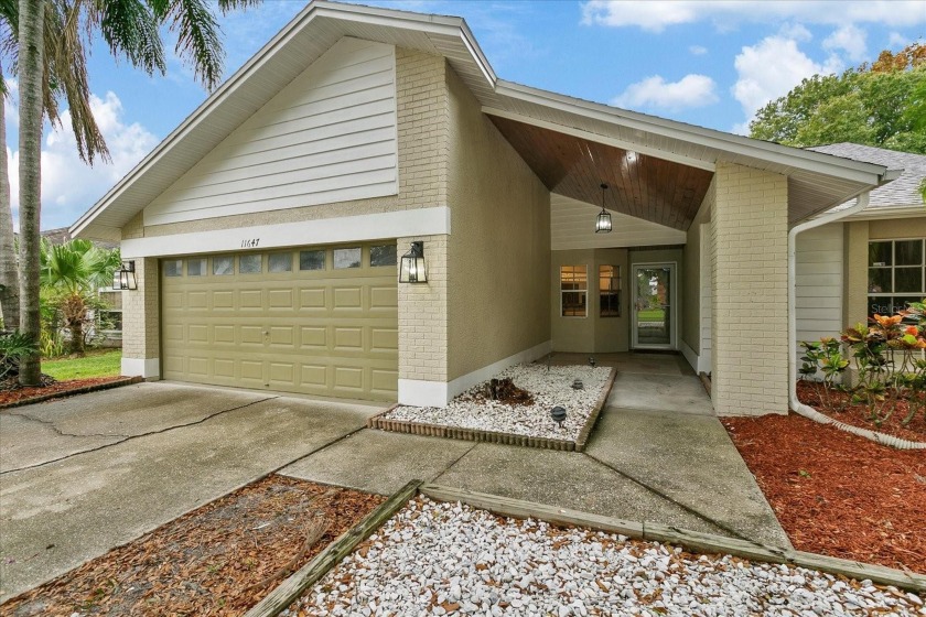 BEAUTIFULLY UPDATED 4 BR/2 BA LAKEFRONT HOME in DESIRABLE - Beach Home for sale in Tampa, Florida on Beachhouse.com