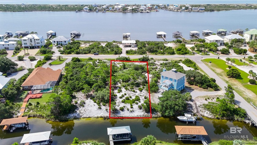 Elevated and deep, this unimproved canal-front lot offers a rare - Beach Lot for sale in Orange Beach, Alabama on Beachhouse.com