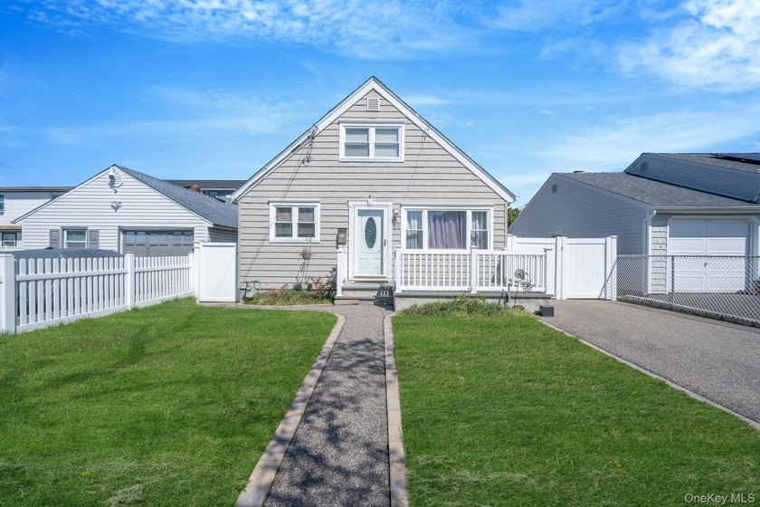 Welcome to this beautifully updated 4-bedroom, 1.5-bath Cape set - Beach Home for sale in Lindenhurst, New York on Beachhouse.com