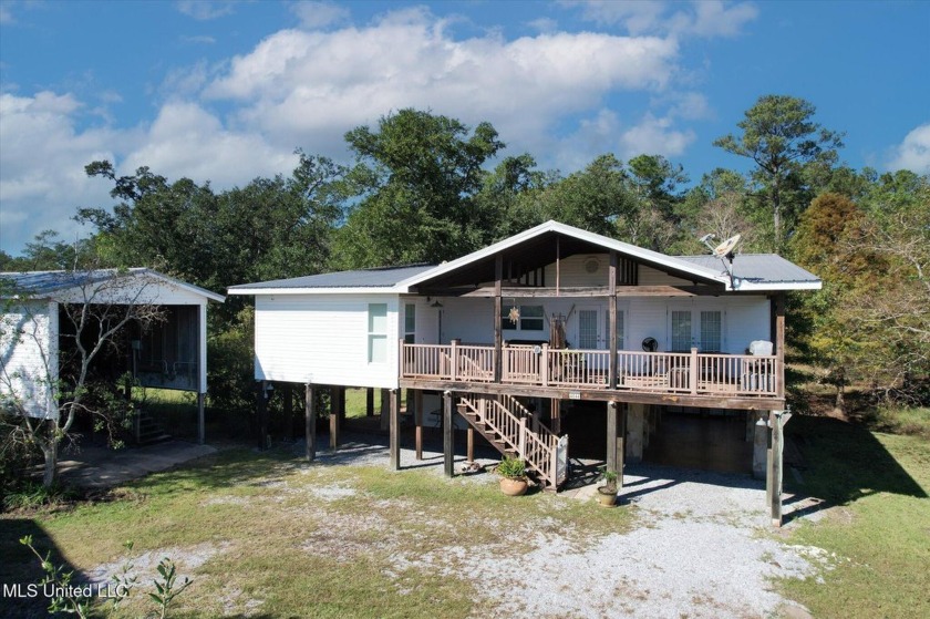 Nestled on a sprawling 1.6-acre lot, this stunning 3-bedroom - Beach Home for sale in Pearlington, Mississippi on Beachhouse.com