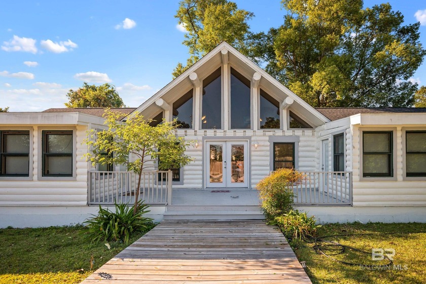 Step into coastal charm with this beautiful log cabin offering - Beach Home for sale in Lillian, Alabama on Beachhouse.com