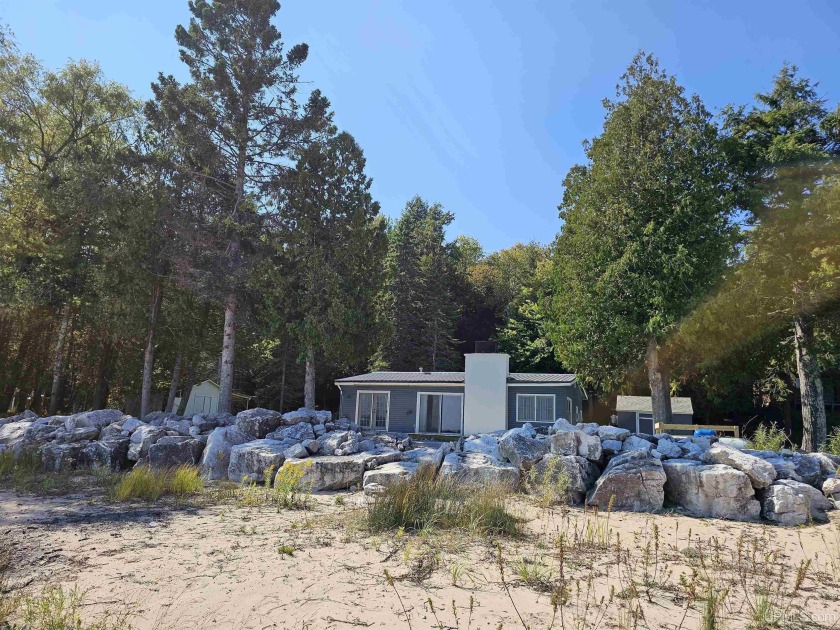 Nestled along 150' of pristine sandy Lake Michigan frontage in - Beach Home for sale in Manistique, Michigan on Beachhouse.com