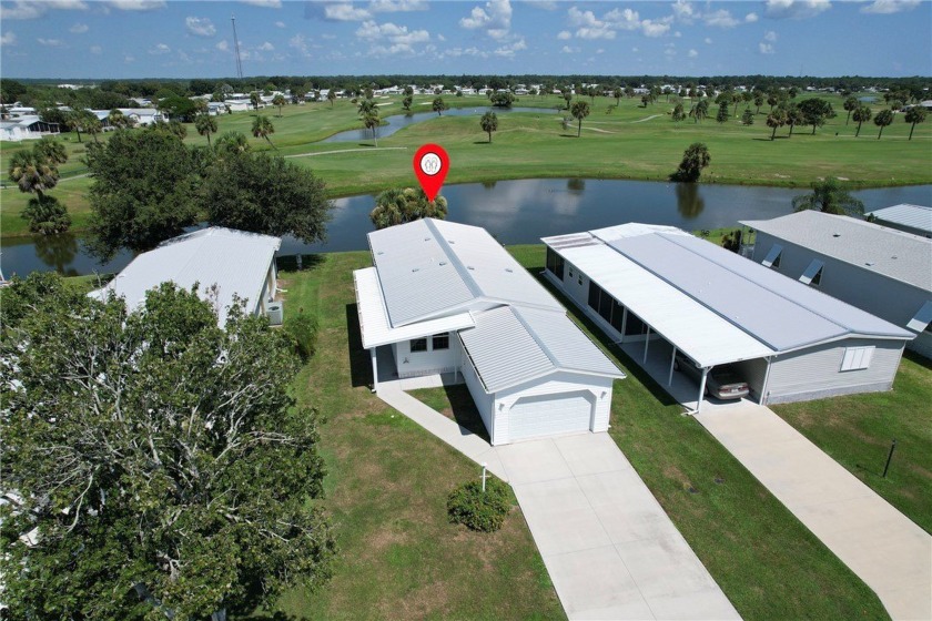 Enjoy direct golf course and water views from this beautifully - Beach Home for sale in Barefoot Bay, Florida on Beachhouse.com