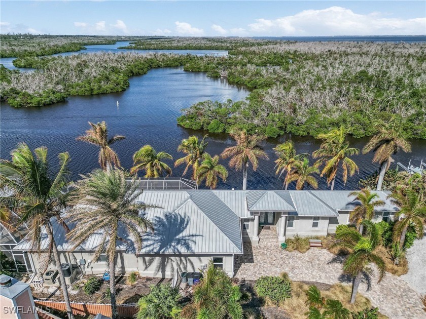 Imagine waking up to this tropical oasis surrounded by towering - Beach Home for sale in St. James City, Florida on Beachhouse.com