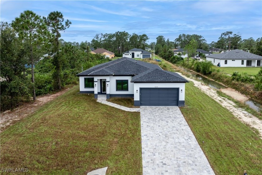 This stunning canal-side new construction home, crafted by a - Beach Home for sale in Lehigh Acres, Florida on Beachhouse.com