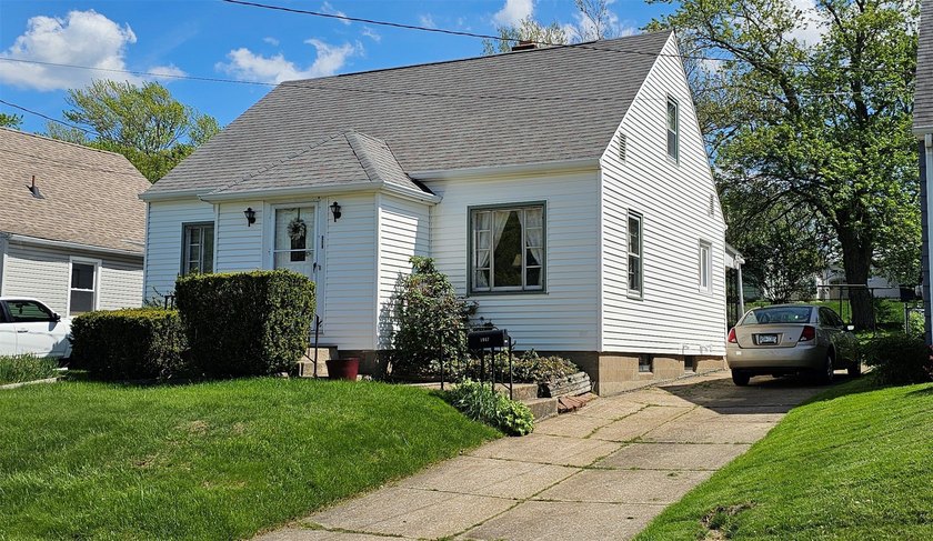 Welcome home to this bright, cheerful cape cod nestled in a - Beach Home for sale in Erie, Pennsylvania on Beachhouse.com