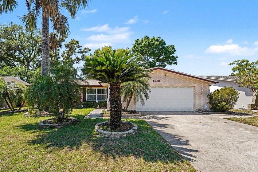 Imagine pulling into your driveway, surrounded by mature palms - Beach Home for sale in Clearwater, Florida on Beachhouse.com