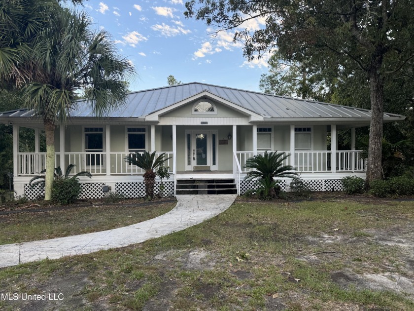 Nestled on a tranquil .39-acre waterfront lot, this beautiful - Beach Home for sale in Gautier, Mississippi on Beachhouse.com