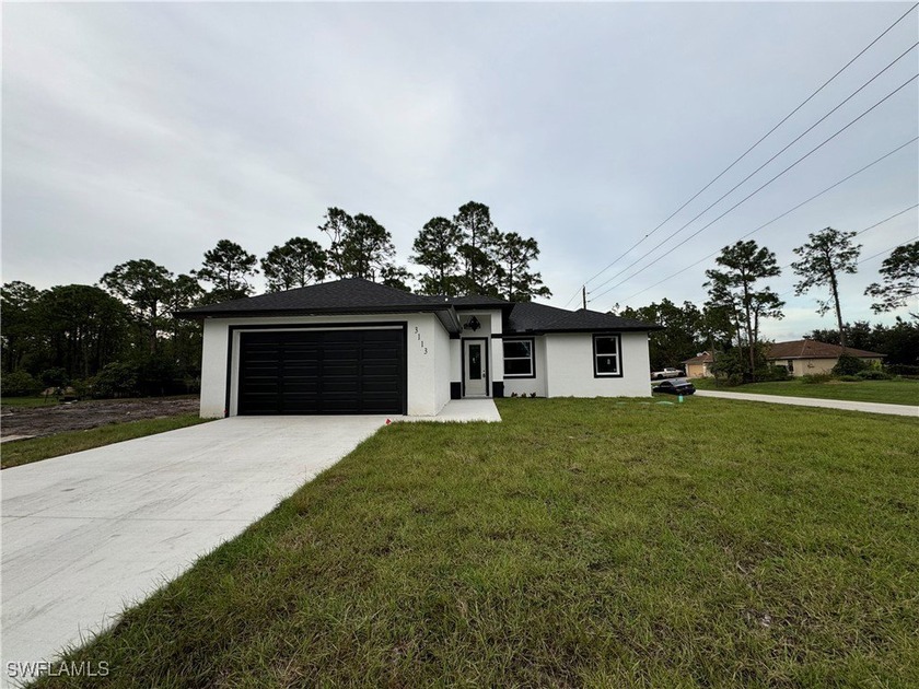 Discover this stunning 3-bedroom, 2-bathroom home situated on a - Beach Home for sale in Lehigh Acres, Florida on Beachhouse.com