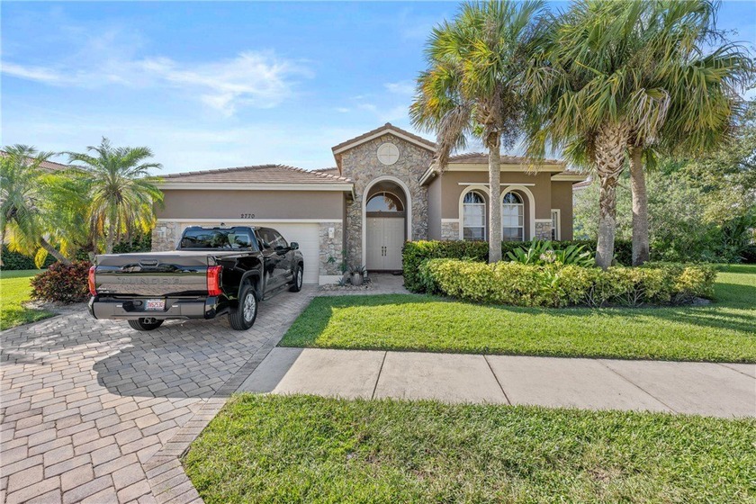 Stunning lake front beauty. Paver driveway, stack stone exterior - Beach Home for sale in Vero Beach, Florida on Beachhouse.com
