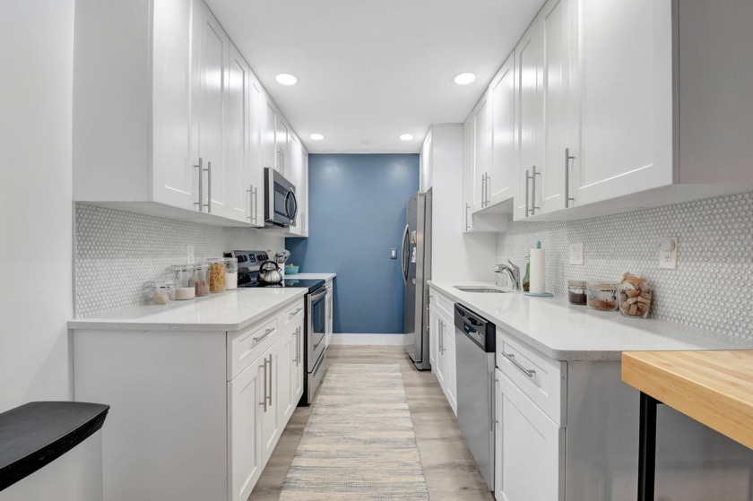 This updated villa features modern white Shaker style kitchen - Beach Home for sale in Boynton Beach, Florida on Beachhouse.com