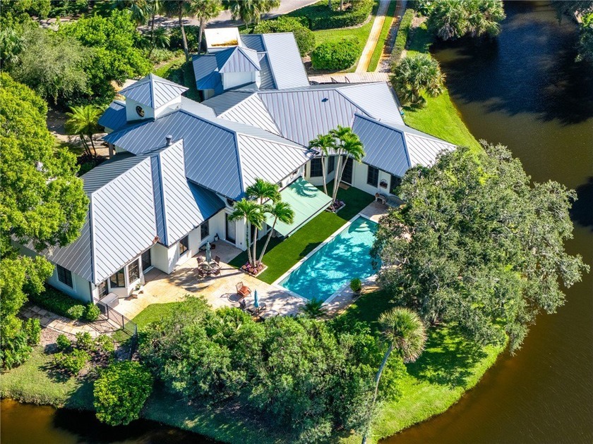 Stunning lake views on 3 sides & beautifully landscaped, this - Beach Home for sale in Vero Beach, Florida on Beachhouse.com