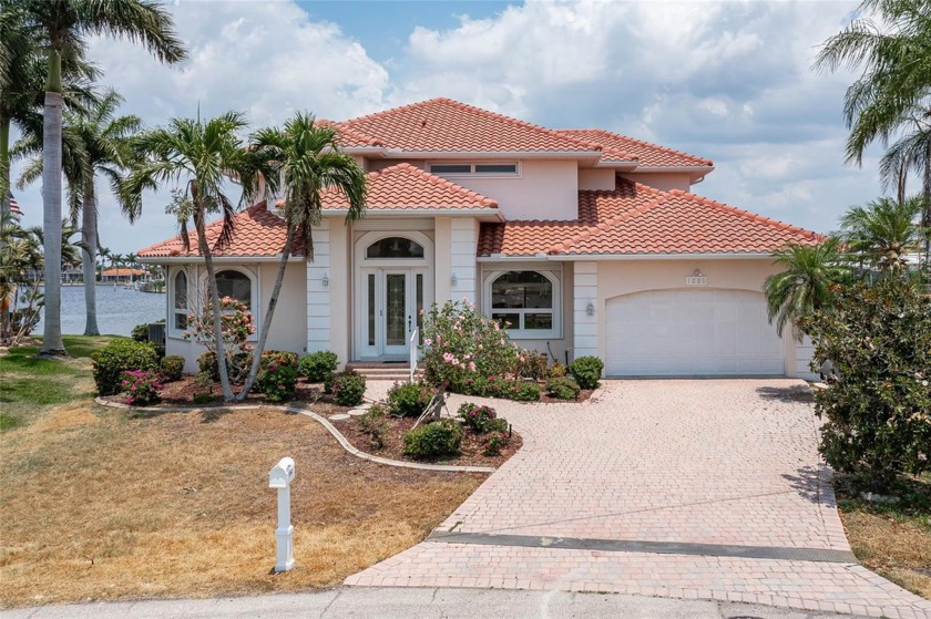 WHAT A VIEW! TWO-STORY, WATERFRONT HOME IN PGI W/**NEW ROOF** - Beach Home for sale in Punta Gorda, Florida on Beachhouse.com