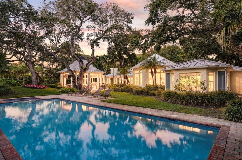 Adorned by vintage live oaks, this exceptional .77 acre property - Beach Home for sale in Vero Beach, Florida on Beachhouse.com