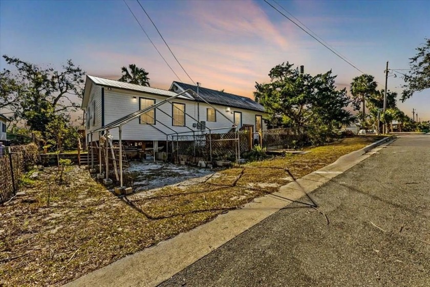 A MUST SEE, HIGH AND DRY HOME ON THREE CITY LOTS. Nestled in the - Beach Home for sale in Cedar Key, Florida on Beachhouse.com