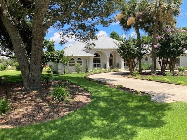 Situated on an oversized corner lot with lush landscaping, this - Beach Home for sale in Navarre, Florida on Beachhouse.com