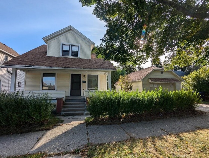 This cozy bungalow has a wide front porch where you can sit in - Beach Home for sale in Sheboygan, Wisconsin on Beachhouse.com