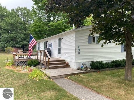 Updated Mobile in Vacation Village with shared frontage on Bass - Beach Home for sale in Elk Rapids, Michigan on Beachhouse.com