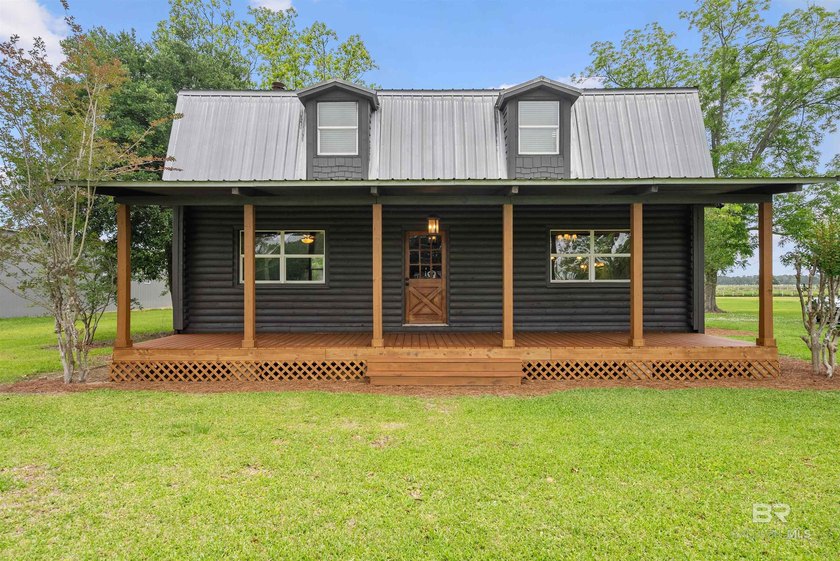 Tucked away on almost 4 acres of flat, green land, this inviting - Beach Home for sale in Fairhope, Alabama on Beachhouse.com