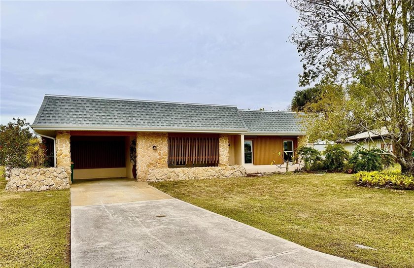 Located on 107 feet of intersecting waterways at the tip of - Beach Home for sale in Port Charlotte, Florida on Beachhouse.com