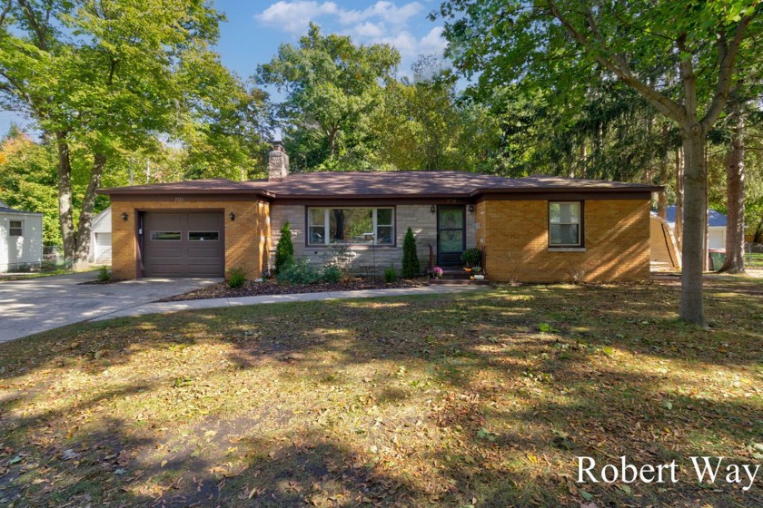 Walk in to a large living room with original wood floors and a - Beach Home for sale in Norton Shores, Michigan on Beachhouse.com