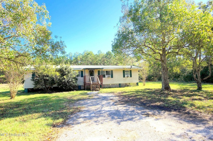 Nestled on a beautiful 3.2-acre lot, this charming 2-bedroom - Beach Home for sale in Bay Saint Louis, Mississippi on Beachhouse.com