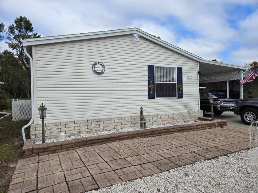 THIS LOVELY FURNISHED 2/2 HOME FEATURES ENCLOSED PATIO WITH - Beach Home for sale in Hudson, Florida on Beachhouse.com