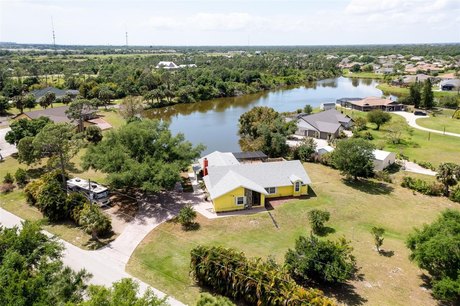 Country Living in this large 4/2/2 home on Lake Suncoast.  Bring - Beach Home for sale in Punta Gorda, Florida on Beachhouse.com