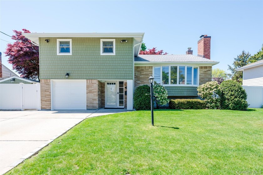Welcome to this beautifully updated split-level home offering - Beach Home for sale in Glen Cove, New York on Beachhouse.com