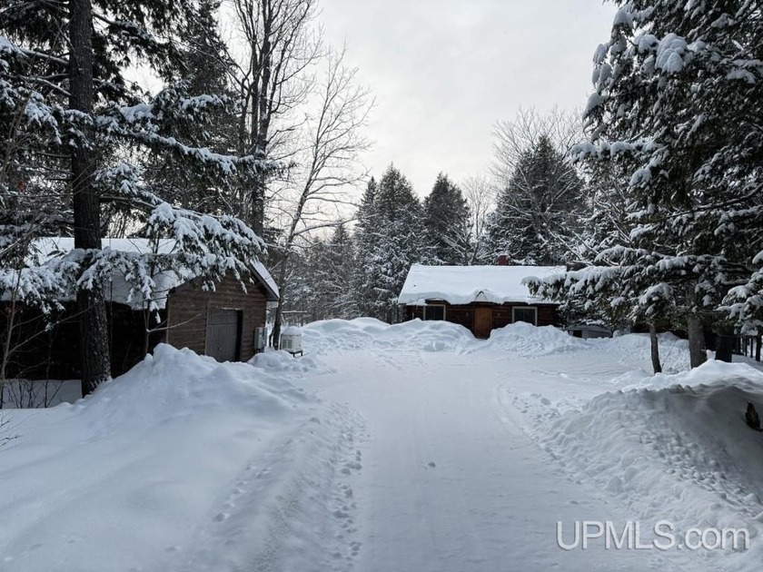 Tucked back at the end of a long, tree-covered drive, this - Beach Home for sale in Skanee, Michigan on Beachhouse.com
