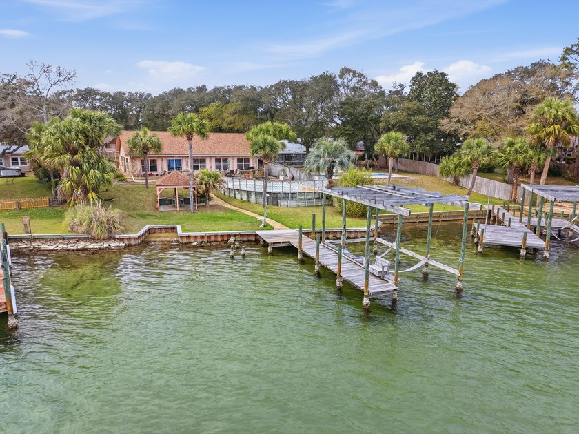 Positioned on 1/2 acre along the tranquil waters of Cinco Bayou - Beach Home for sale in Fort Walton Beach, Florida on Beachhouse.com