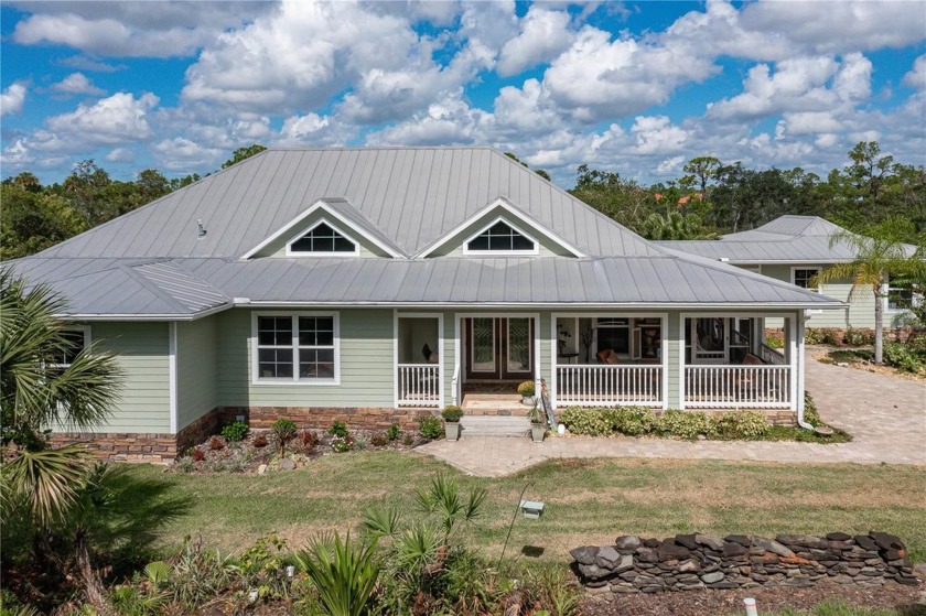 CUSTOM HOME W/IDYLLIC COUNTRY SETTING ON OVER AN ACRE WITH CANAL - Beach Home for sale in Port Charlotte, Florida on Beachhouse.com